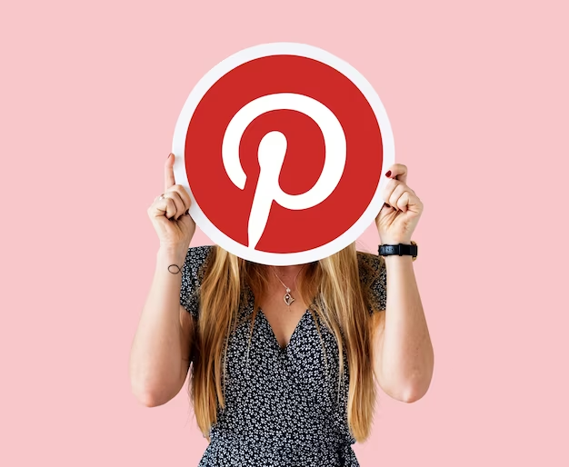 A girl holding a Pinterest app icon